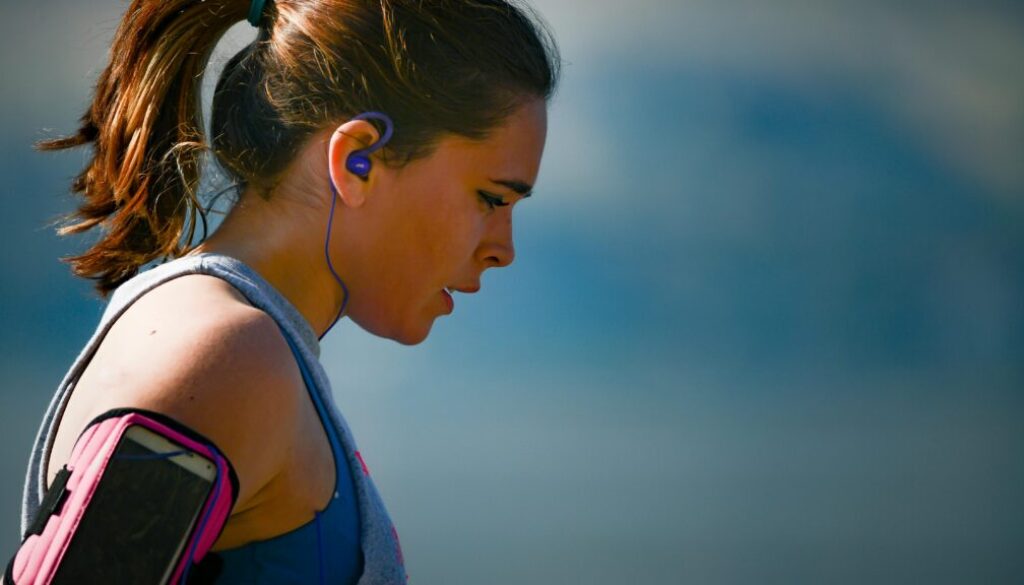 Person exercising outdoors, engaged in a cardio workout routine.