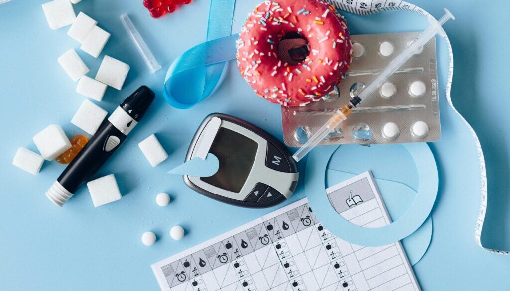 Assorted diabetes medications including pills, insulin vials, and syringes arranged on a table to represent the best medications for diabetes management.