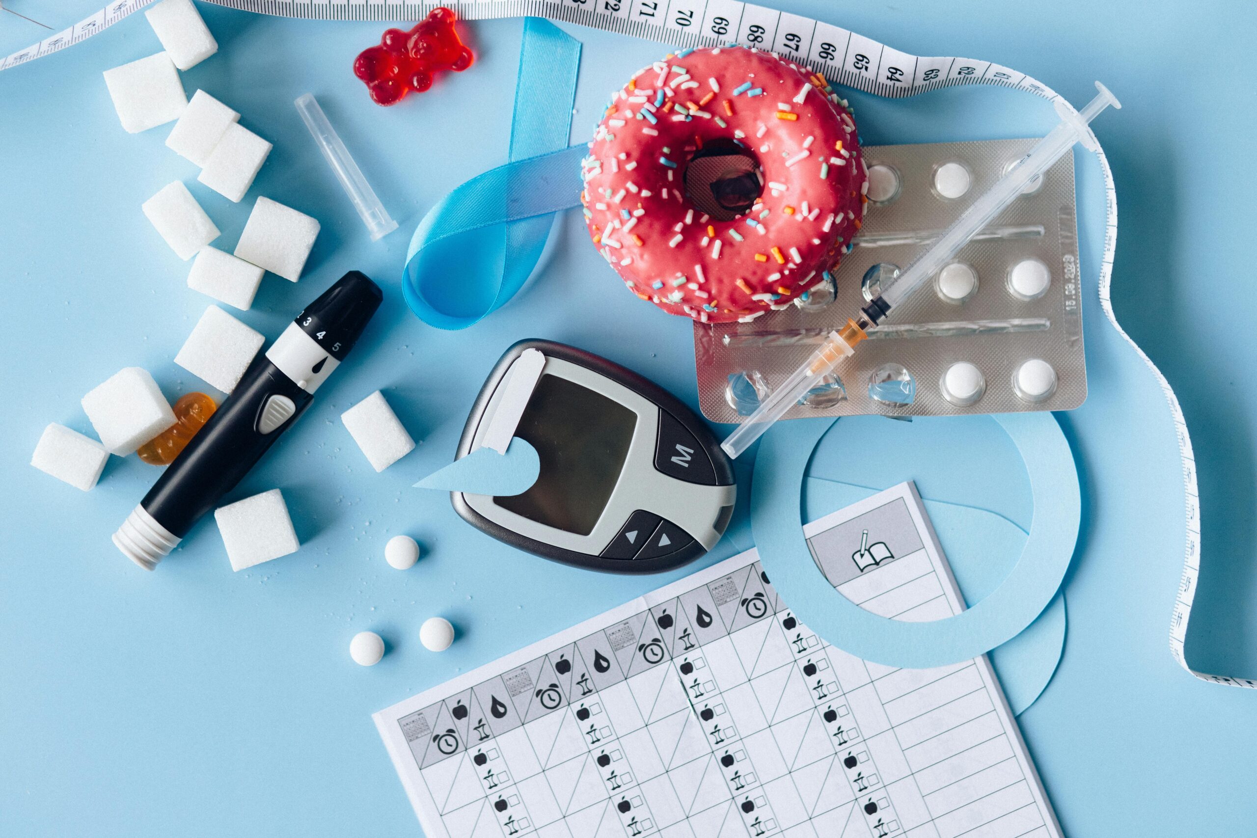 Assorted diabetes medications including pills, insulin vials, and syringes arranged on a table to represent the best medications for diabetes management.