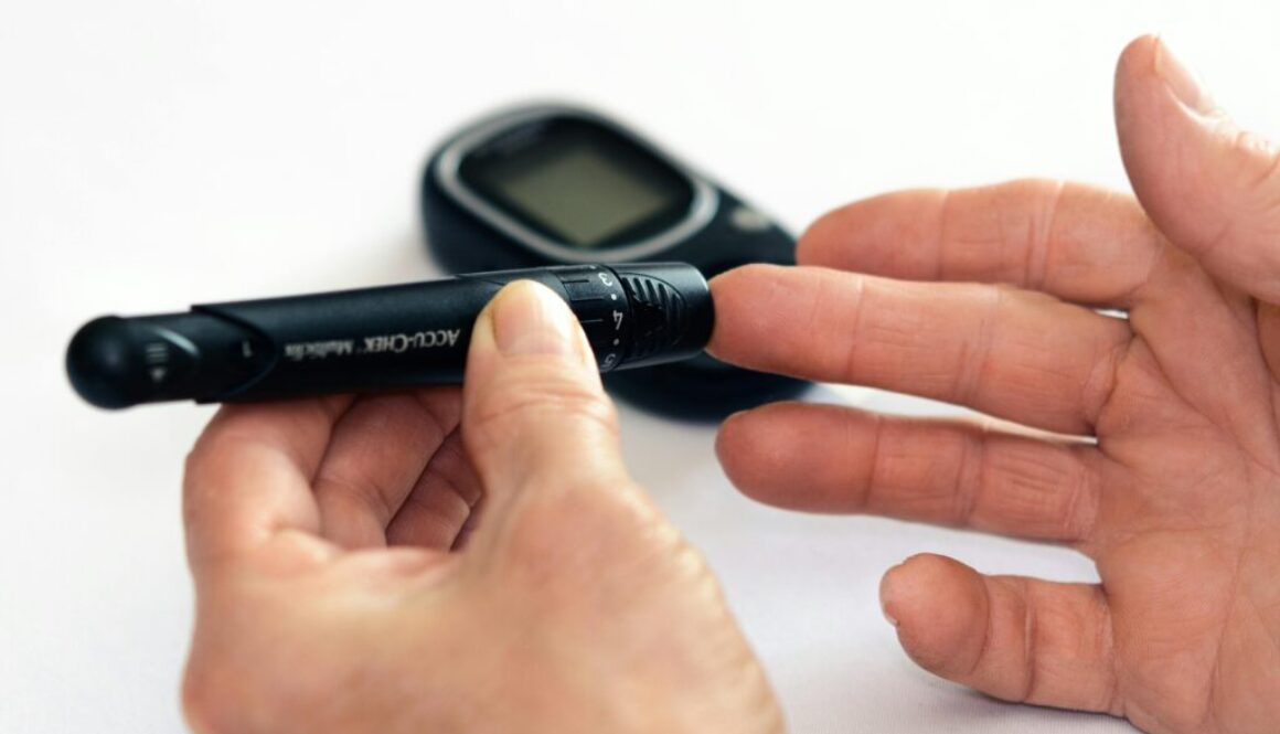 Person using a glucometer to self-monitor glucose levels at home, demonstrating blood sugar testing for diabetes management.
