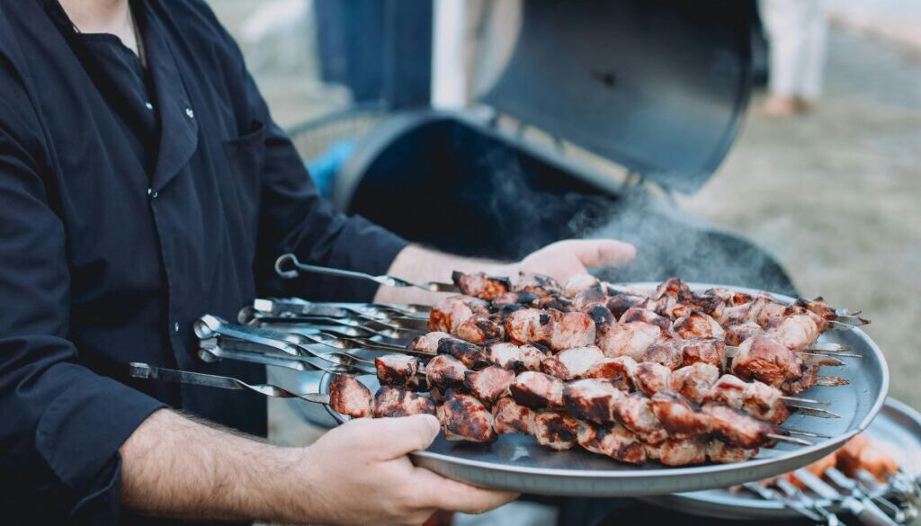 Grilling vegetables and meat on a barbecue, showcasing a variety of colorful, healthy ingredients cooking over an open flame