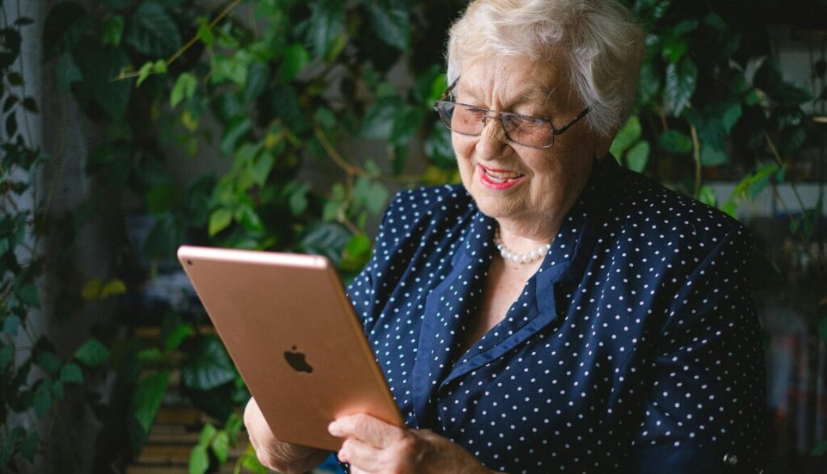 Senior woman confidently using a tablet at home, representing Empowering Independence: Strategies for Aging in Place.