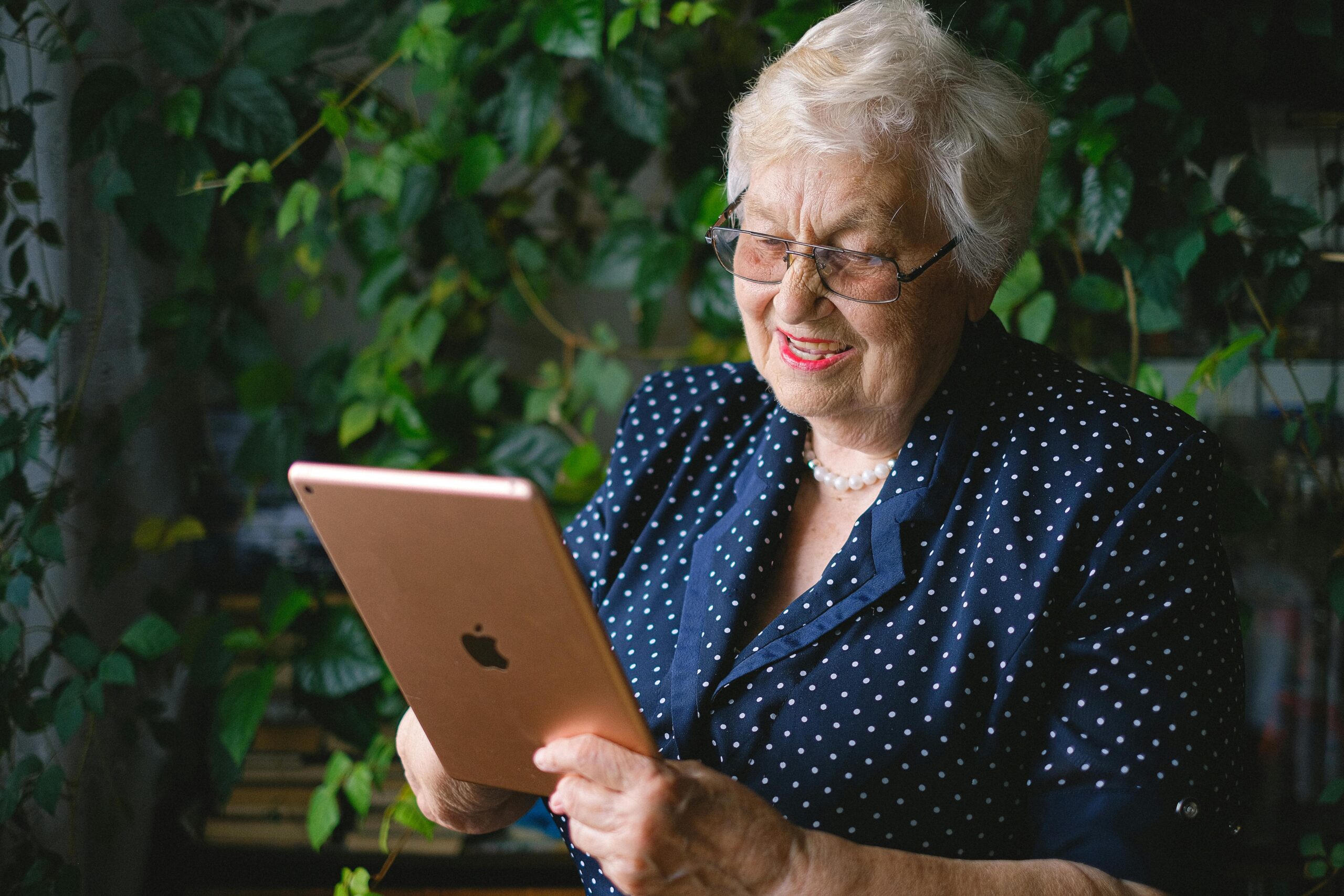 Senior woman confidently using a tablet at home, representing Empowering Independence: Strategies for Aging in Place.